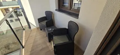 a group of chairs sitting on the side of a building at Apartman Gora in Irig