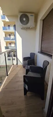 a room with chairs and a fan on the wall at Apartman Gora in Irig