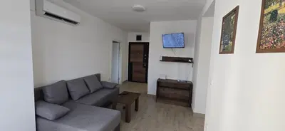 a living room with a couch and a tv at Apartman Gora in Irig