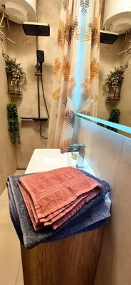 a bathroom with a sink and a mirror and towels at Tailor Palace in Belgrade