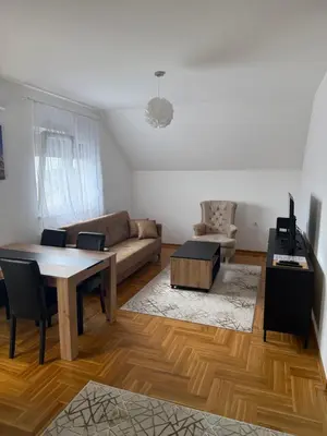 a living room with a table and a couch at Port 5 in Kalugjerica