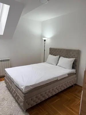 a bed with white sheets and pillows in a room at Port 5 in Kalugjerica