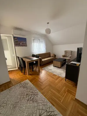 a living room with a table and a couch at Port 5 in Kalugjerica