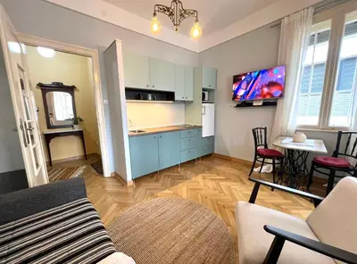 a kitchen and living room with a couch and a table at Belgrade ST6 in Belgrade