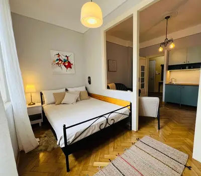 a bedroom with a bed and a living room at Belgrade ST6 in Belgrade