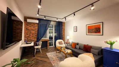 a living room with a couch and a table at Ollio Balkan Escape in Belgrade
