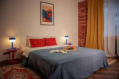 a bedroom with a bed with a tray of food on it at Ollio Balkan Escape in Belgrade