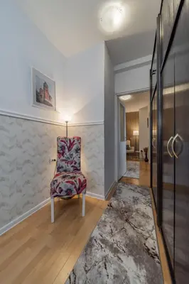 a living room with a chair and a hallway at Panorama Novi Beograd in Belgrade