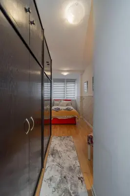 a bedroom with a bed in a room with a door at Panorama Novi Beograd in Belgrade