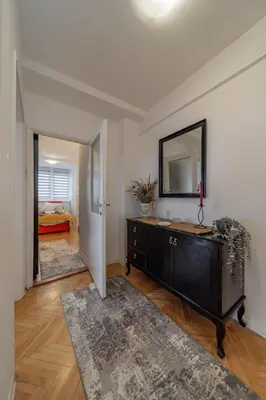 a living room with a dresser and a mirror at Panorama Novi Beograd in Belgrade