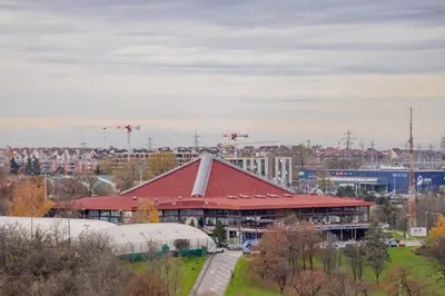a large building with a red roof in a city at Panorama Novi Beograd in Belgrade