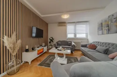 a living room with a couch and a tv at Panorama Novi Beograd in Belgrade