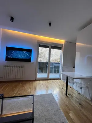 a living room with a table and a large window at Belgrade Lounge in Belgrade