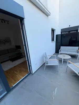 a room with a patio with a couch and a table at Belgrade Lounge in Belgrade