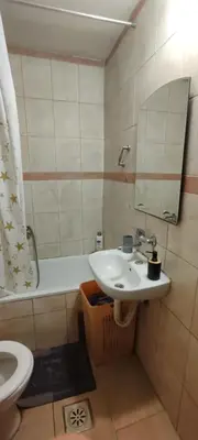 a bathroom with a sink and a tub and a toilet at Spacious House with Terrace - Vozdovac in Belgrade