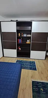 a bedroom with a bed and a closet at Spacious House with Terrace - Vozdovac in Belgrade