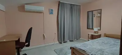 a bedroom with a bed and a desk and a mirror at Spacious House with Terrace - Vozdovac in Belgrade
