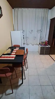 a kitchen with a table and chairs and a refrigerator at Spacious House with Terrace - Vozdovac in Belgrade