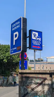 a parking sign on a pole next to a street at The Belfort Townhomes - Green Lux Loft in Belgrade