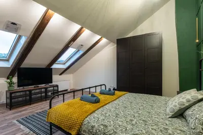 a bedroom with a bed with two blue towels on it at The Belfort Townhomes - Green Lux Loft in Belgrade