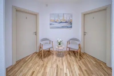 a room with two chairs and a table and a painting at Spa King Apartments 3 in Belgrade