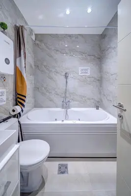 a white bathroom with a tub and a toilet at Spa King Apartments 3 in Belgrade