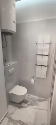 a white bathroom with a toilet in a room at Apartment Hilandarska 2 in Belgrade