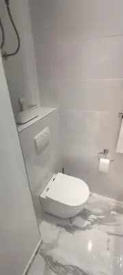 a white bathroom with a white toilet in a room at Apartment Hilandarska 2 in Belgrade