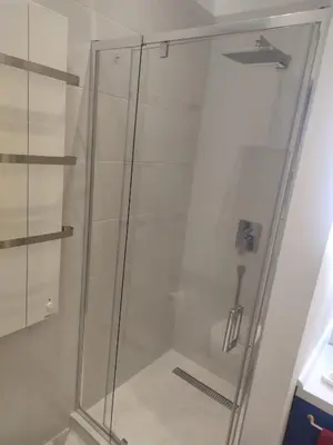 a shower with a glass door in a bathroom at Apartment Hilandarska 2 in Belgrade