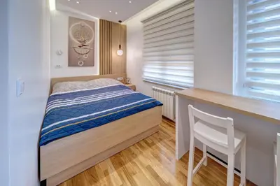 a bedroom with a bed and a desk and a chair at Jacuzzi Spa King Apartments FREE PARKING in Belgrade