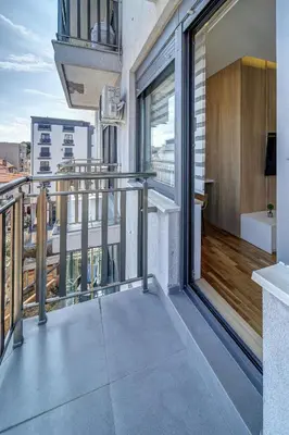 an apartment balcony with a view of a city at Jacuzzi Spa King Apartments FREE PARKING in Belgrade