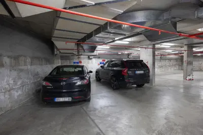 two cars are parked in a parking garage at Jacuzzi Spa King Apartments FREE PARKING in Belgrade