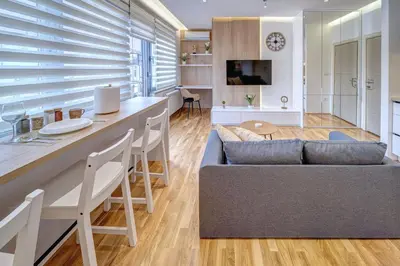 a living room with a couch and a table at Jacuzzi Spa King Apartments FREE PARKING in Belgrade