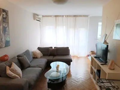 a living room with a couch and a coffee table at Relax Apartment in Belgrade