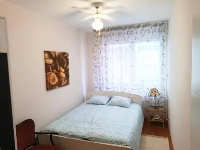 a bedroom with a bed and a window at Relax Apartment in Belgrade