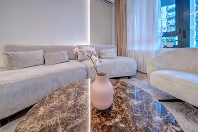 a living room with a couch and a vase on a table at Belgrade Waterfront Ana Premium Living in Belgrade