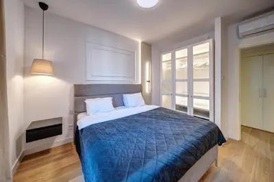 a bedroom with a bed with a blue comforter at Belgrade Waterfront Ana Premium Living in Belgrade