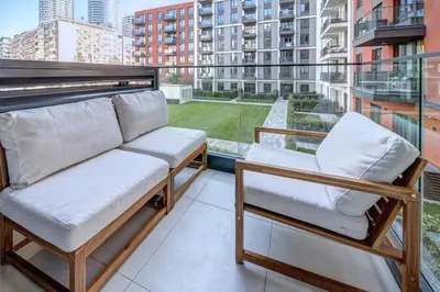 a balcony with two chairs and a view of a building at Belgrade Waterfront Ana Premium Living in Belgrade