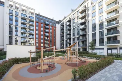 a playground in the middle of two apartment buildings at Belgrade Waterfront Ana Premium Living in Belgrade
