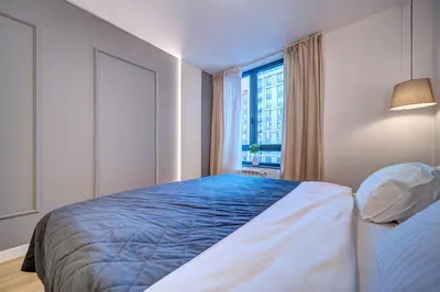 a bedroom with a blue bed and a window at Belgrade Waterfront Ana Premium Living in Belgrade
