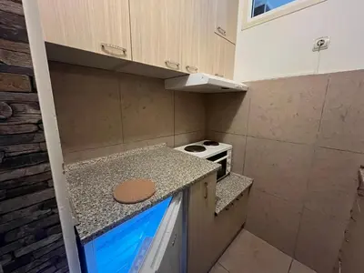 a small kitchen with a stove and a counter top at Bridge studio in Belgrade