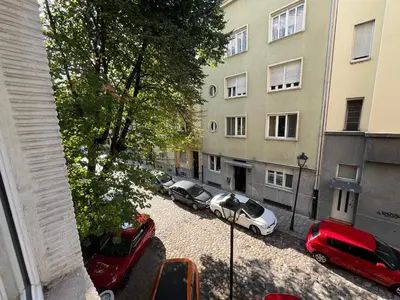 an aerial view of cars parked in a parking lot next to a building at Bridge studio in Belgrade