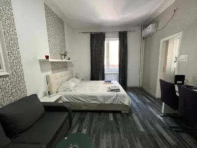 a small room with a bed and a couch at Bridge studio in Belgrade