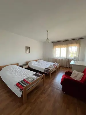 a room with two beds and a couch in it at Loza House in Arandjelovac