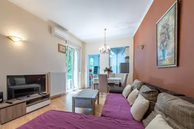 a living room with a couch and a tv at Apartments Terazije in Belgrade