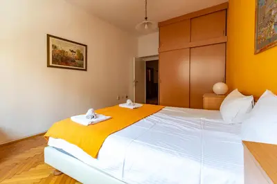 a bedroom with a large bed with two towels at Apartments Terazije in Belgrade