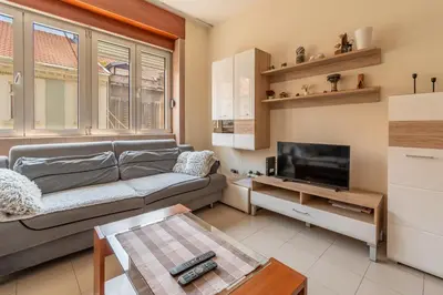 a living room with a couch and a tv at Apartments Terazije in Belgrade