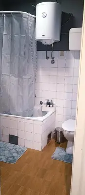 a bathroom with a tub and a toilet and a sink at Resava Apartment in Belgrade