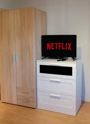 a tv sitting on top of a white dresser at Resava Apartment in Belgrade