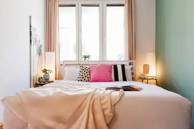 a bedroom with a large white bed with pink pillows at Sunwave with Terrace 280 Mbps Old Town Renovated in Belgrade